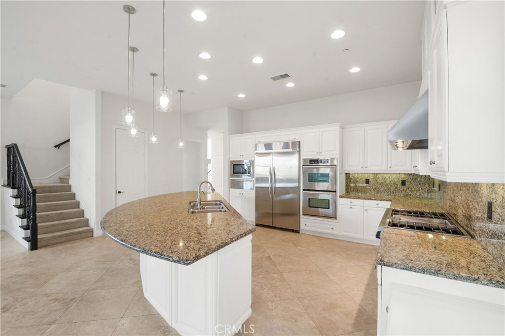 4925 Lone Acres Court Rancho Cucamonga, CA 91737 - Photo 22 of 68 a kitchen with stainless steel appliances granite countertop a sink stove and refrigerator