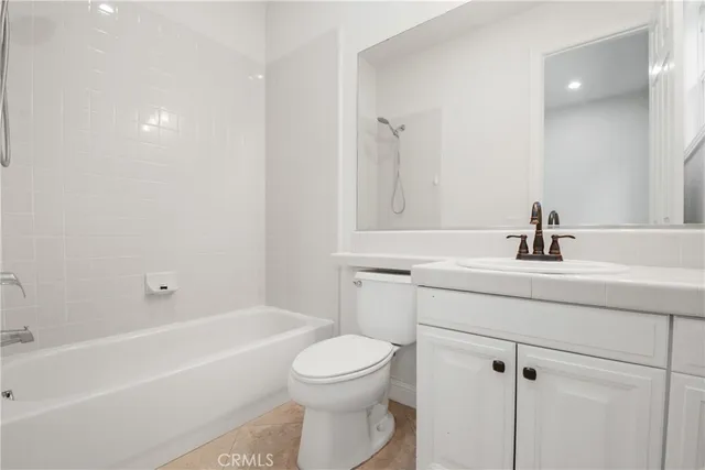 a front view of house with yard and trees in the background