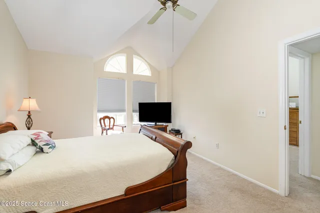 a bedroom with a bed and a flat tv screen