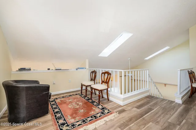 a living room with furniture a rug and white walls