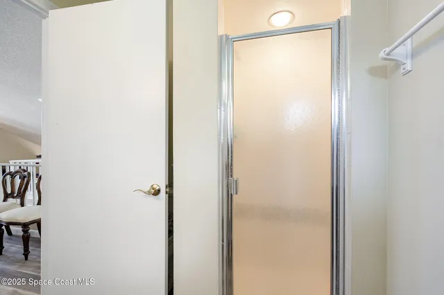 a bathroom with a glass shower door