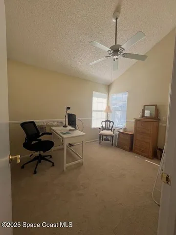 a living room with furniture and a ceiling fan