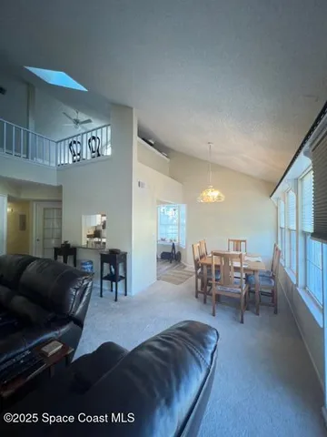 a living room with furniture a dining table and chairs with wooden floor