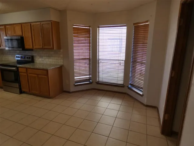 a kitchen with a sink a stove and cabinets