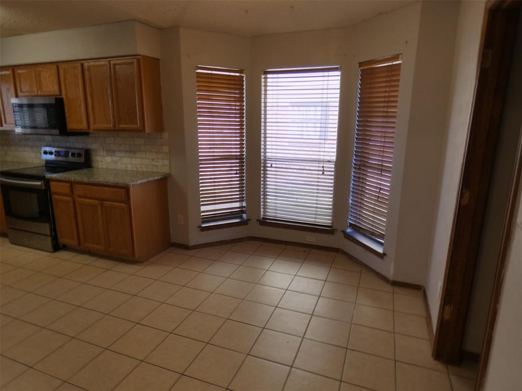 7110 Ridgeview Drive Rowlett, TX 75089 - Photo 15 of 27 a kitchen with a sink a stove and cabinets