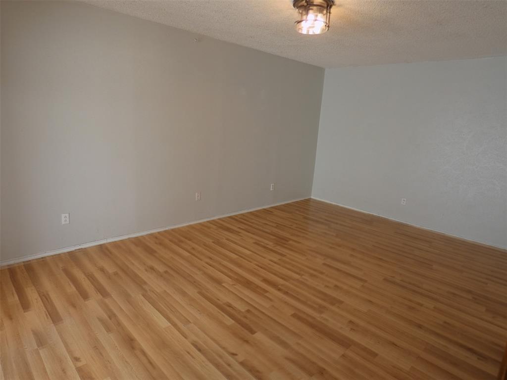 7110 Ridgeview Drive Rowlett, TX 75089 - Photo 16 of 27 a view of an empty room with wooden floor