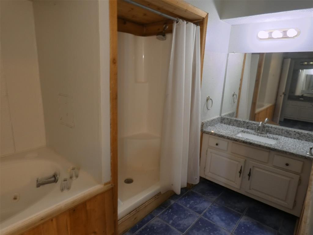 7110 Ridgeview Drive Rowlett, TX 75089 - Photo 18 of 27 a bathroom with a granite countertop sink and a mirror