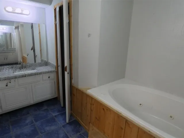 a bathroom with a bathtub and a sink