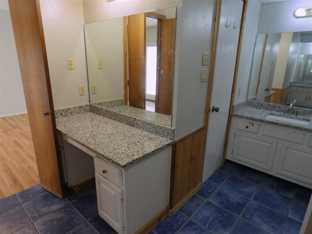 7110 Ridgeview Drive Rowlett, TX 75089 - Photo 20 of 27 a bathroom with a granite countertop sink and a mirror