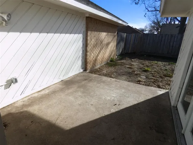 a view of backyard with wooden fence
