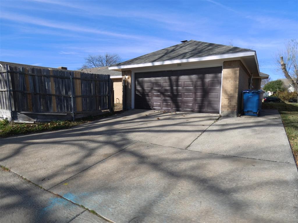 7110 Ridgeview Drive Rowlett, TX 75089 - Photo 27 of 27 a front view of a house with a garden and wooden fence