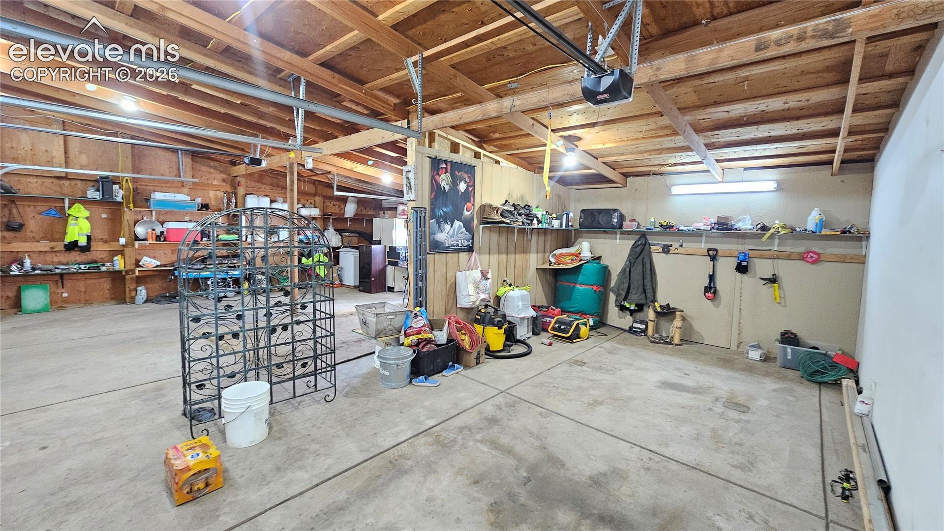 3835 Sengbeil Road Yoder, CO 80864 - Photo 37 of 48 Spacious garage featuring exposed wood beam ceilings and concrete flooring