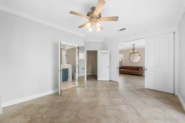 a view of an empty room with a ceiling fan