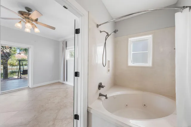 a white bath tub sitting next to a shower