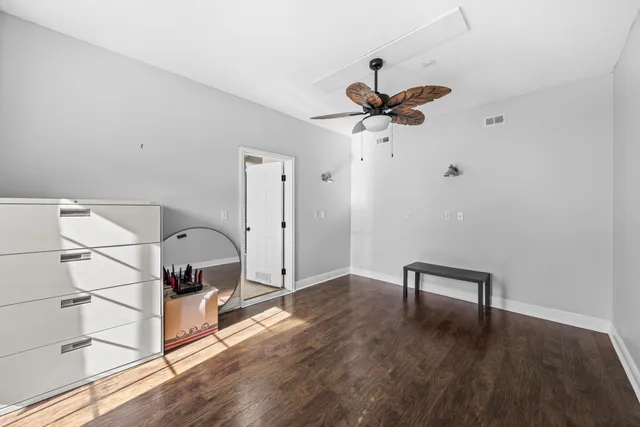 a view of a chandelier fan and wooden floor