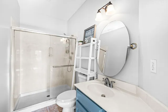 a bathroom with a sink a toilet and a mirror