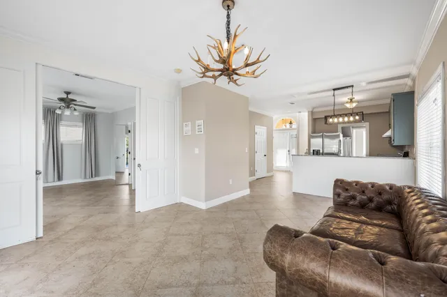 a living room with furniture and a chandelier