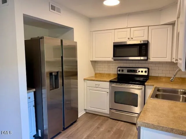 a kitchen with a refrigerator stove and microwave