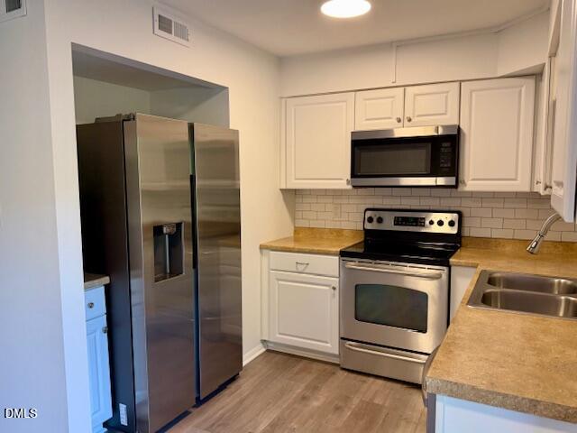 1208 Manassas Court, Unit A Raleigh, NC 27609 - Photo 7 of 16 a kitchen with a refrigerator stove and microwave
