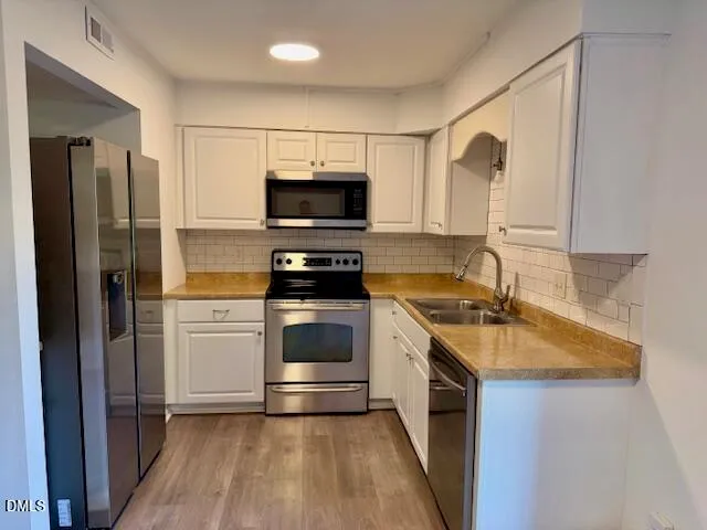 a kitchen with a sink stove and refrigerator