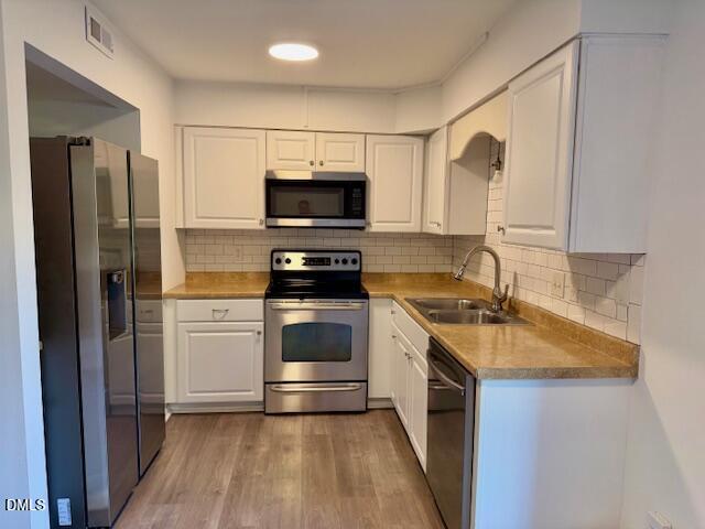 1208 Manassas Court, Unit A Raleigh, NC 27609 - Photo 8 of 16 a kitchen with a sink stove and refrigerator