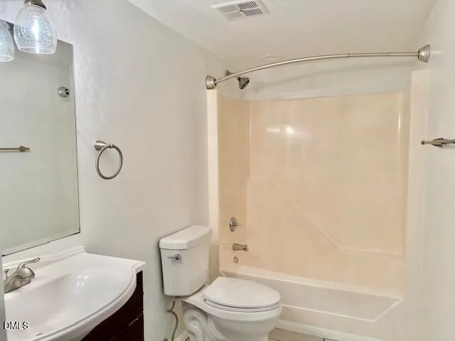 a bathroom with a granite countertop toilet sink and shower