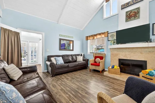 a living room with furniture fireplace and flat screen tv