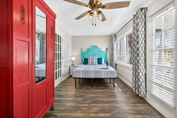 a spacious bedroom with a bed and a chandelier