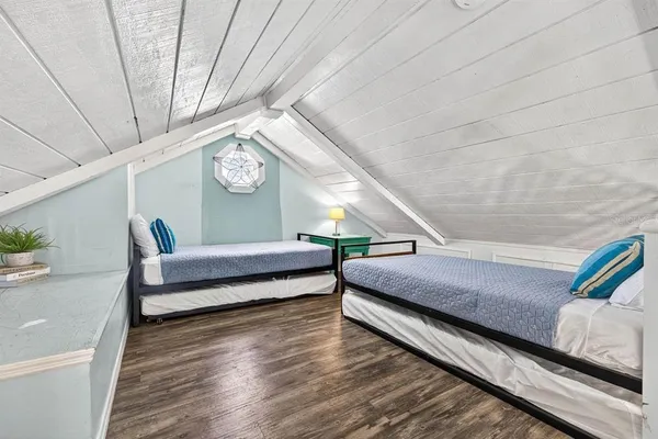 a bedroom with furniture and a wooden floor