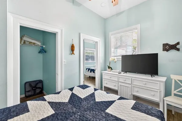 a bedroom with a bed and a flat screen tv