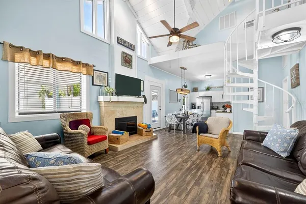 a living room with furniture a fireplace and a large window