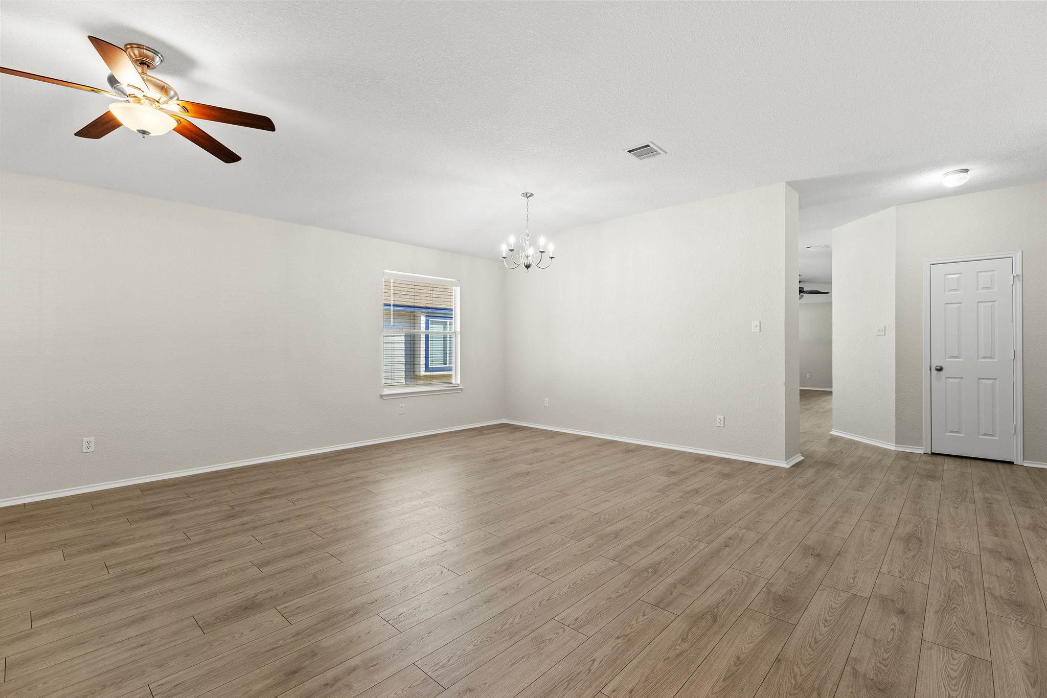 335 Altamont Street Hutto, TX 78634 - Photo 13 of 40 an empty room with wooden floor ceiling fan and window