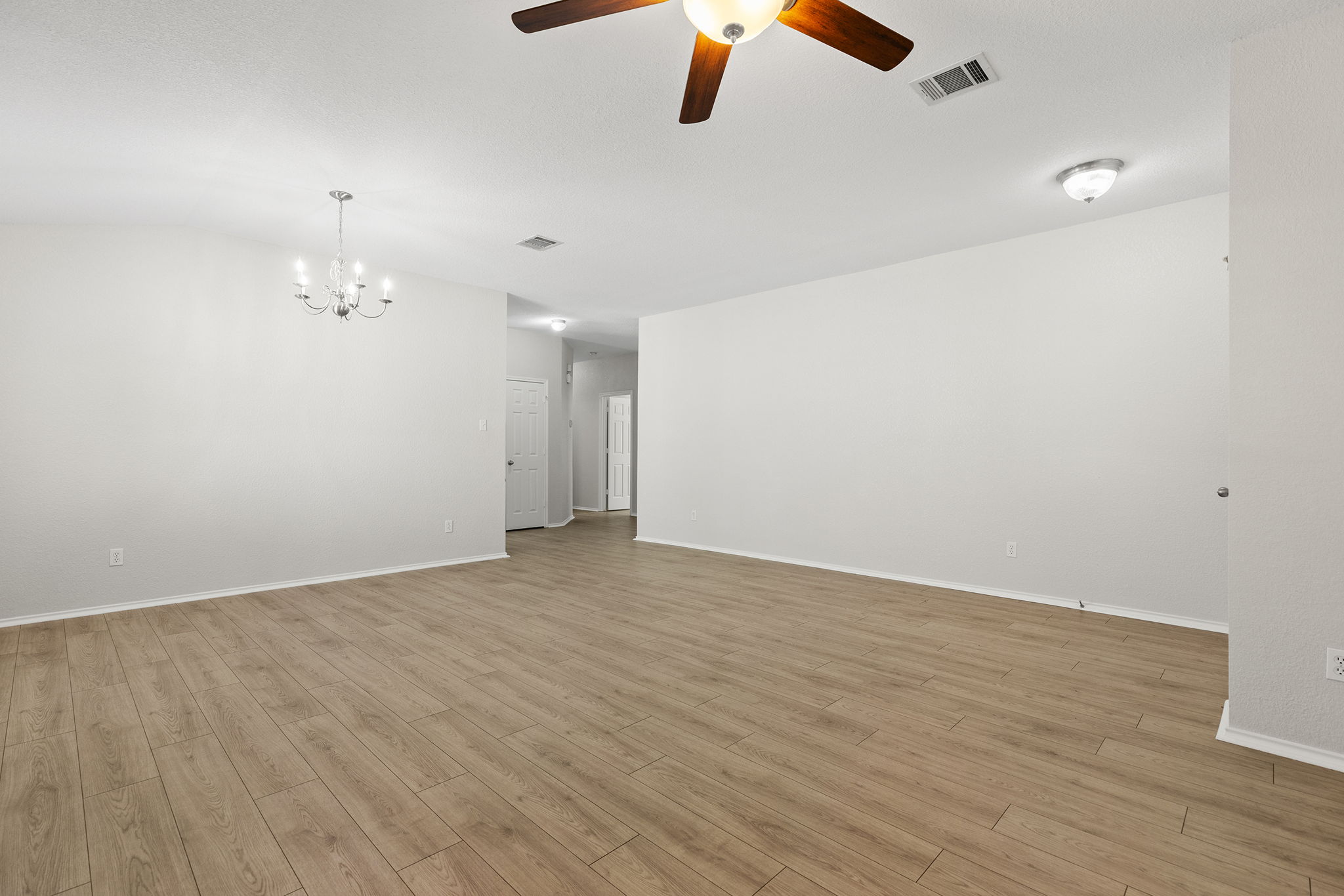 335 Altamont Street Hutto, TX 78634 - Photo 14 of 40 an empty room with wooden floor fan and windows