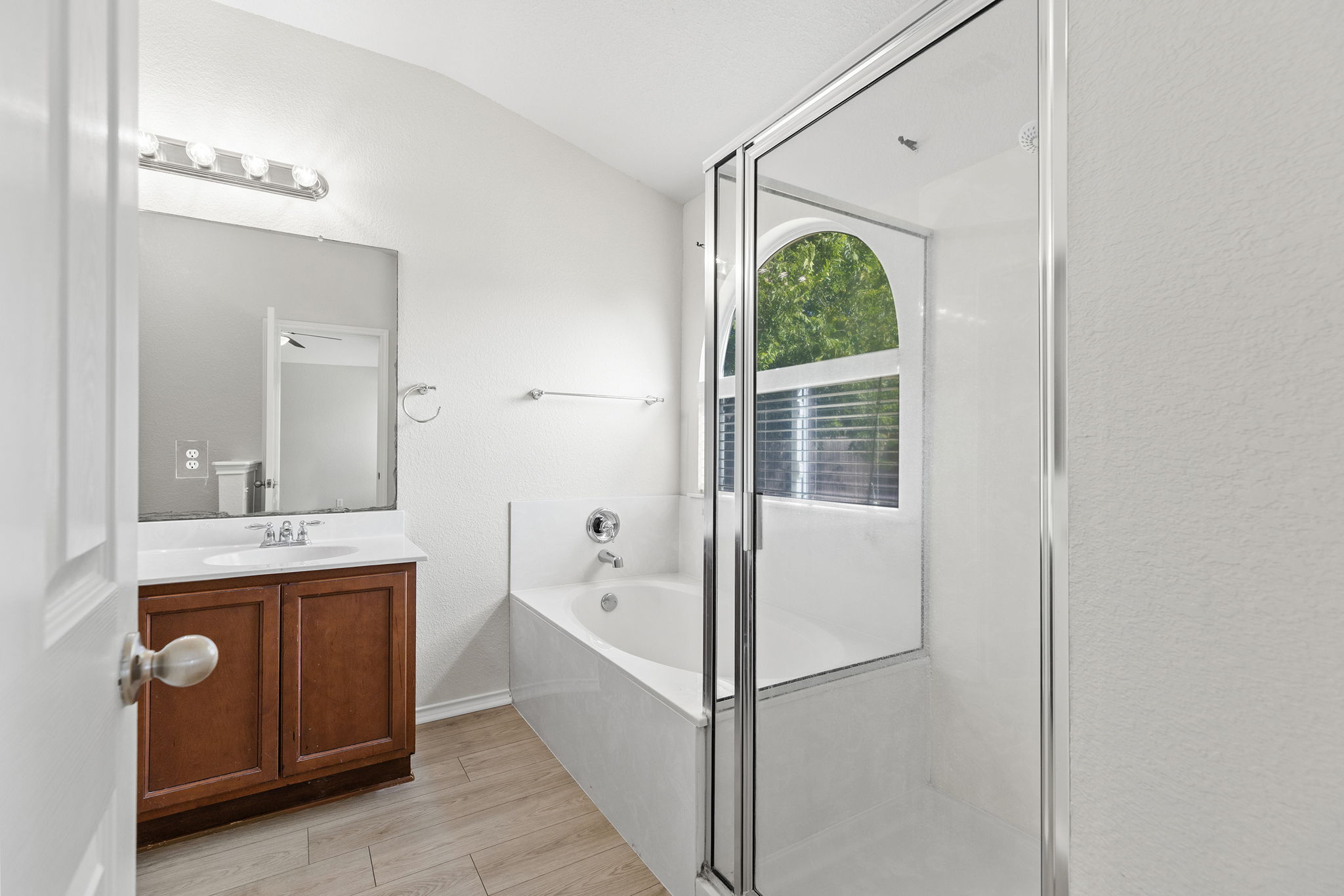335 Altamont Street Hutto, TX 78634 - Photo 17 of 40 a bathroom with a tub sink shower and mirror