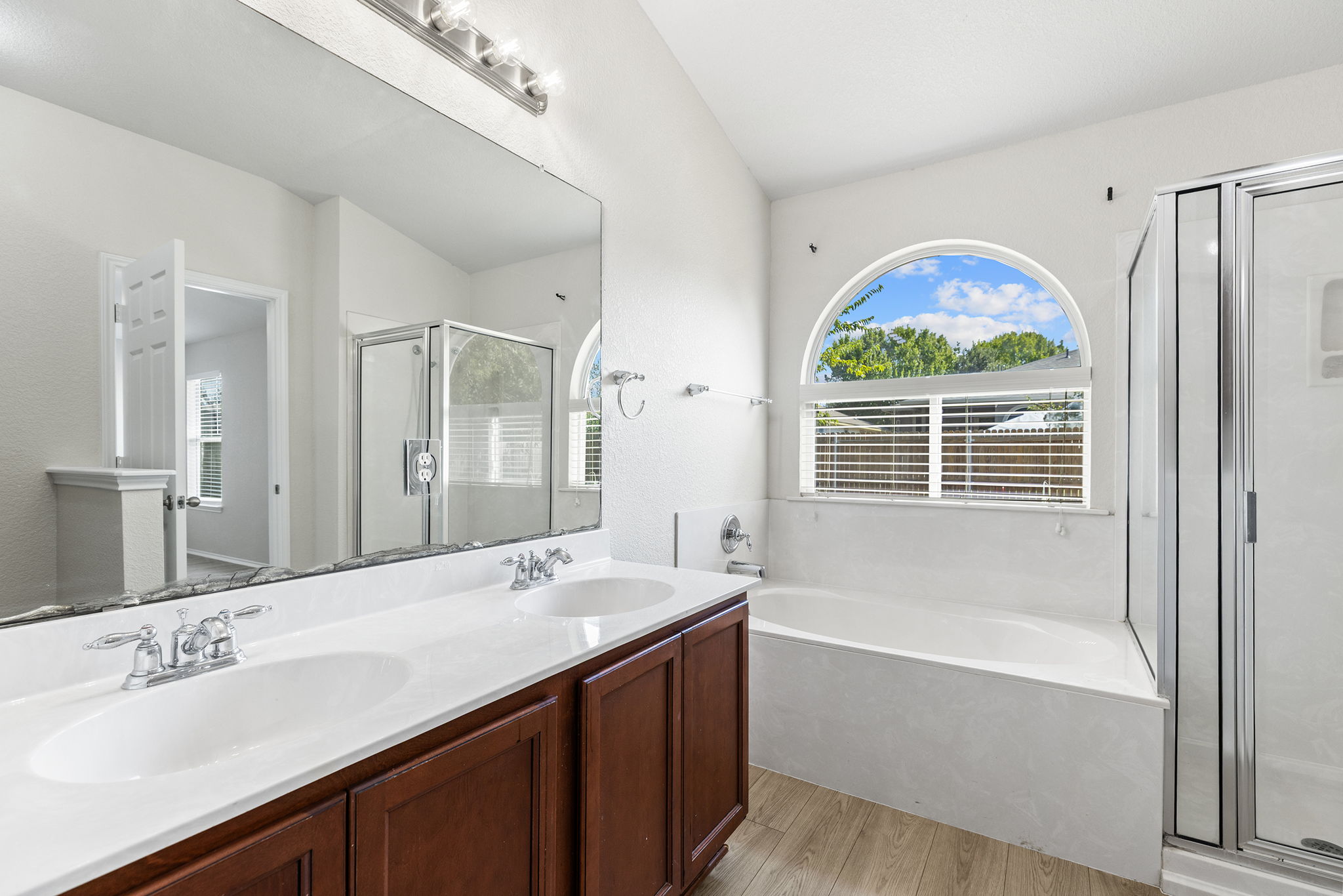 335 Altamont Street Hutto, TX 78634 - Photo 18 of 40 a bathroom with a granite countertop tub sink and mirror
