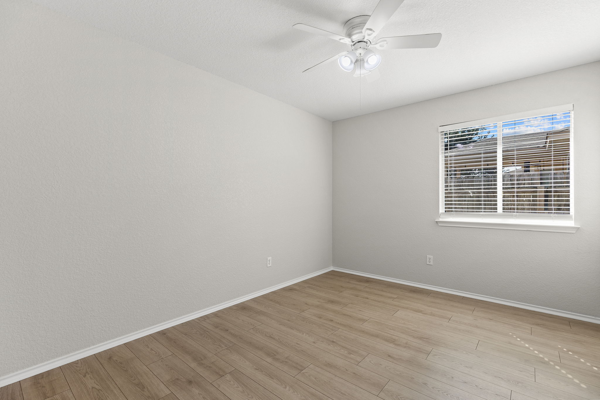335 Altamont Street Hutto, TX 78634 - Photo 29 of 40 wooden floor in an empty room with a window