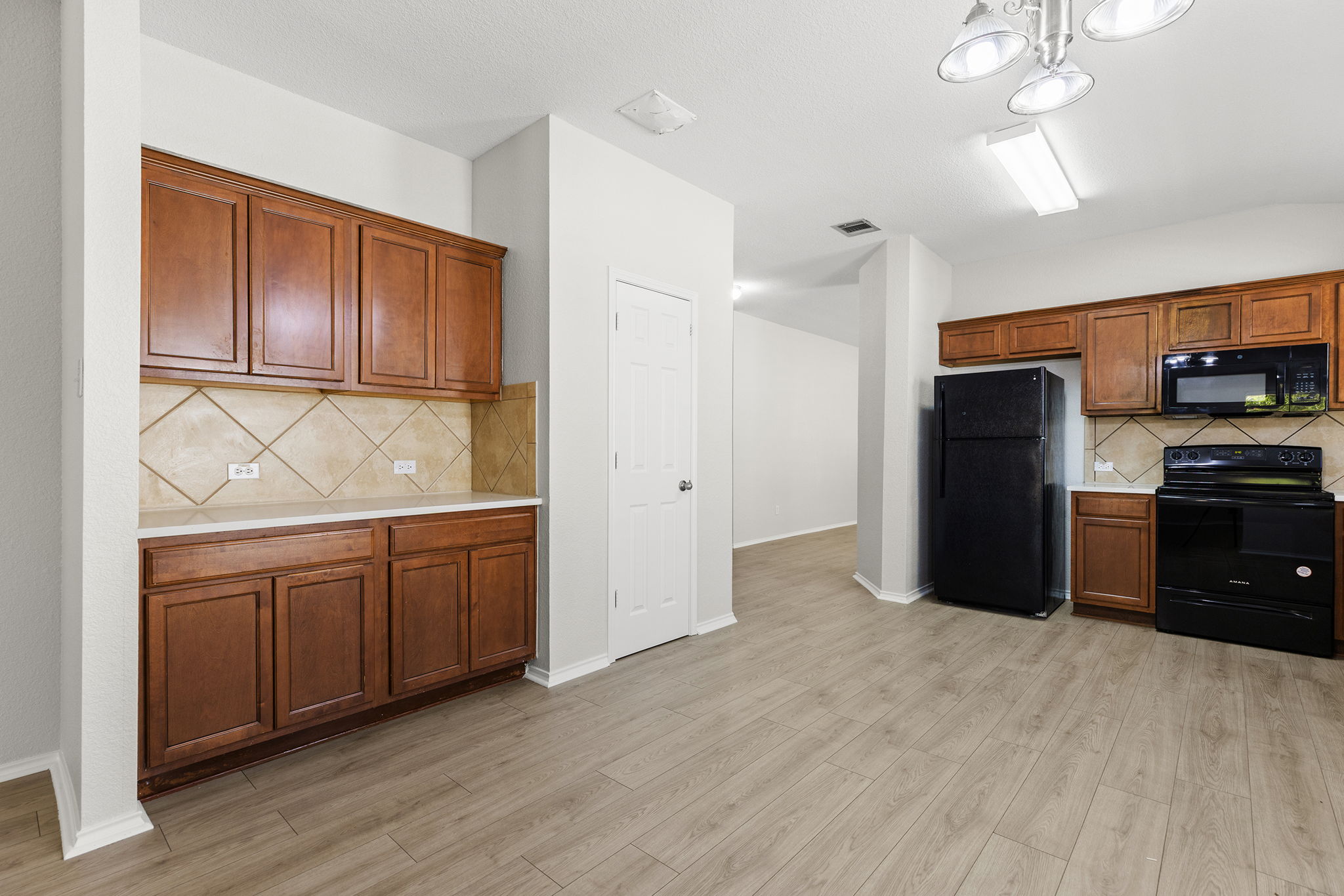 335 Altamont Street Hutto, TX 78634 - Photo 3 of 40 a kitchen with stainless steel appliances granite countertop a refrigerator and a sink