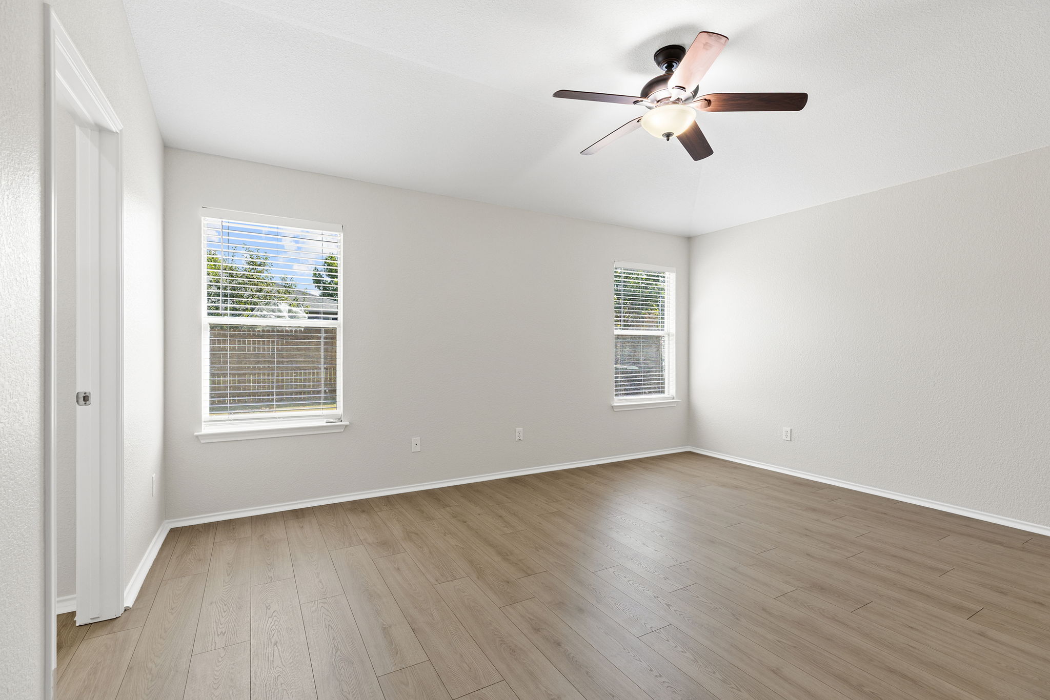 335 Altamont Street Hutto, TX 78634 - Photo 31 of 40 a view of an empty room with wooden floor and a window