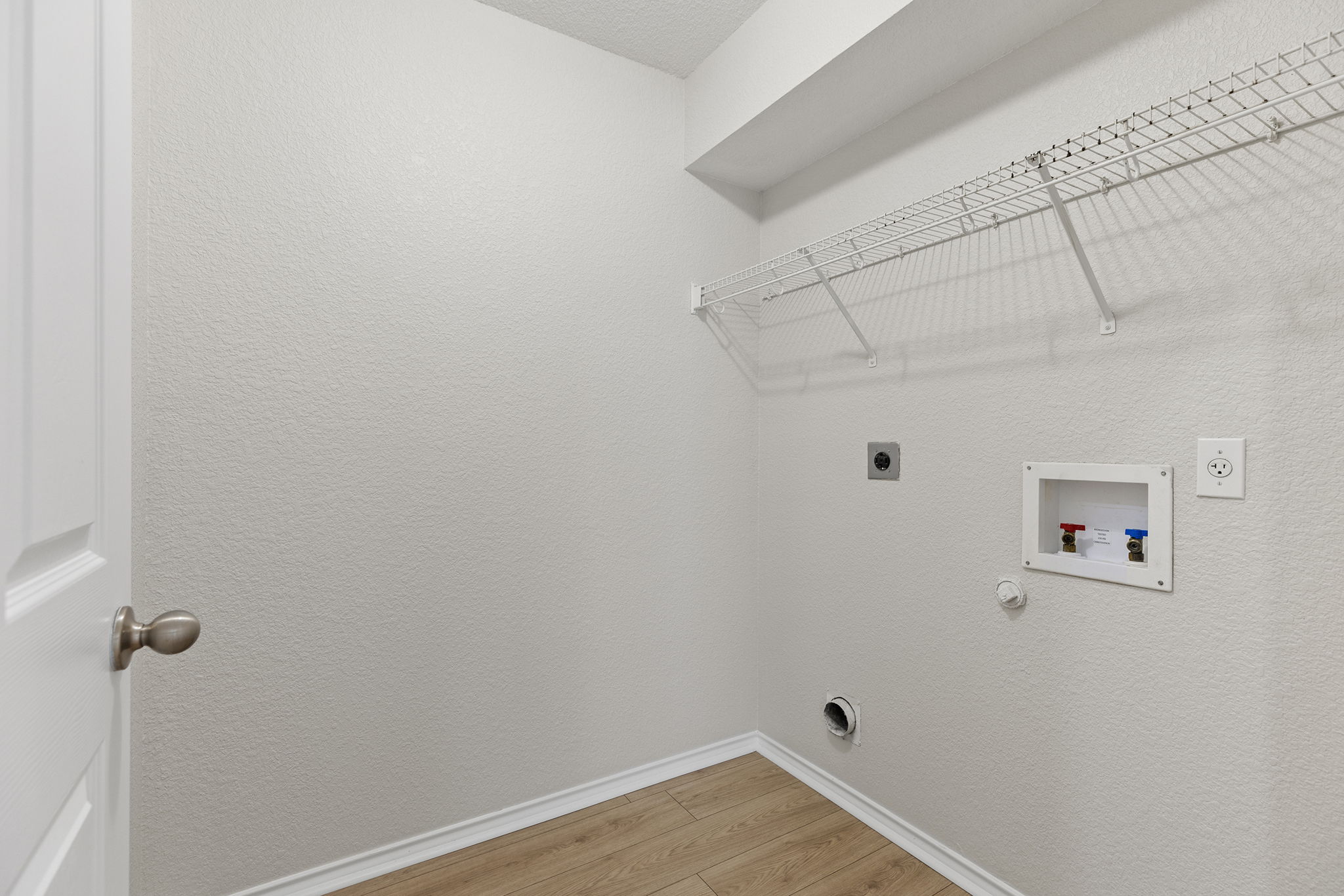 335 Altamont Street Hutto, TX 78634 - Photo 32 of 40 a view of a room with racks on the wall