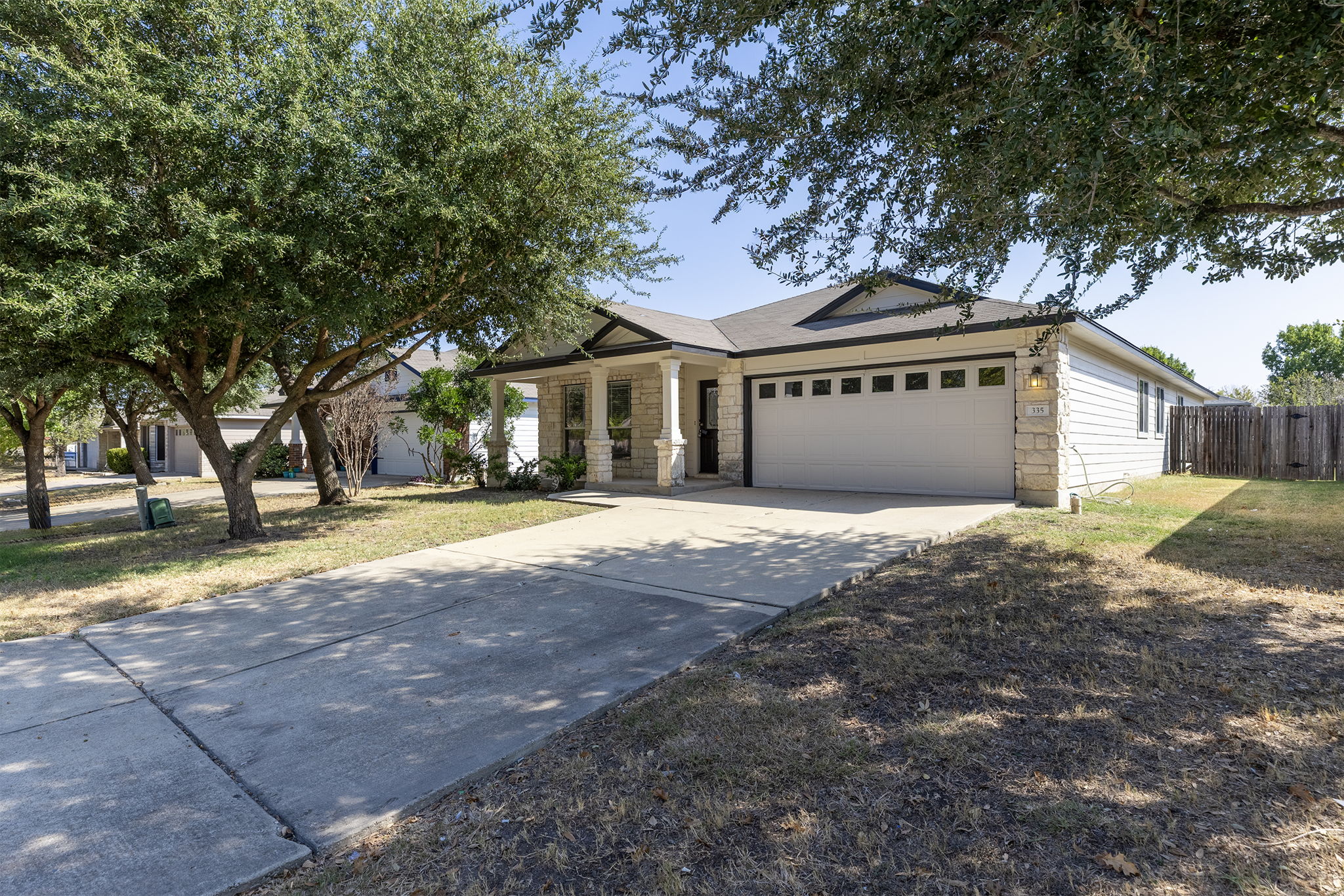 335 Altamont Street Hutto, TX 78634 - Photo 38 of 40 a front view of a house with a yard and garage