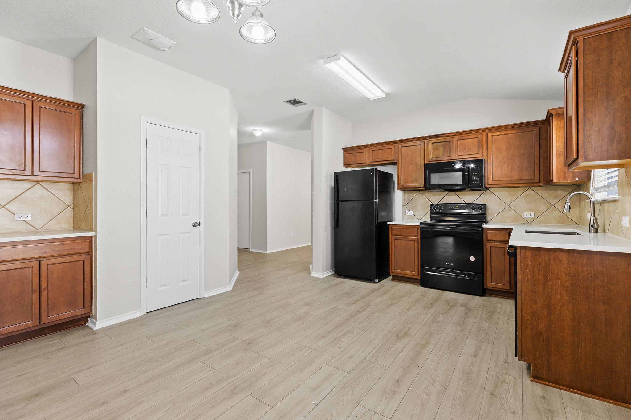 335 Altamont Street Hutto, TX 78634 - Photo 5 of 40 a kitchen with stainless steel appliances granite countertop a refrigerator stove and sink