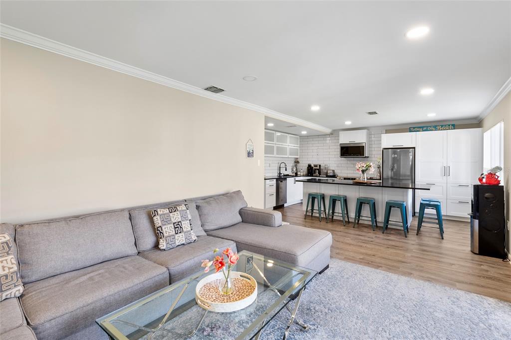 1579 Greenlea Drive, Unit 12 Clearwater, FL 33755 - Photo 11 of 42 a living room with furniture and kitchen view