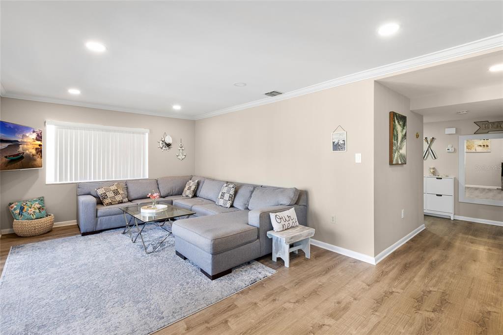 1579 Greenlea Drive, Unit 12 Clearwater, FL 33755 - Photo 18 of 42 a living room with furniture and wooden floor