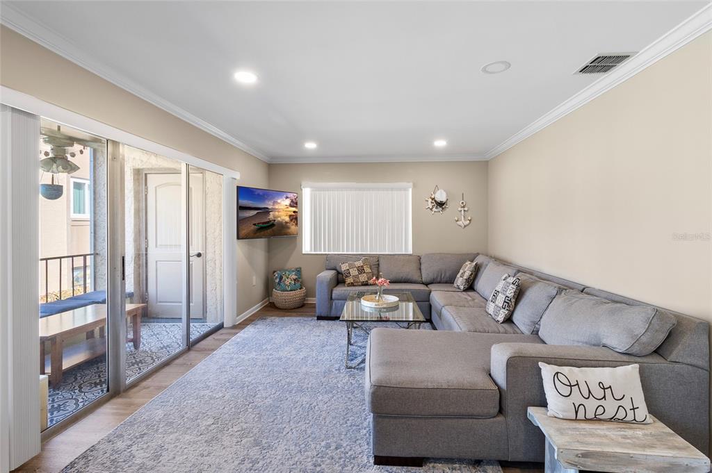 1579 Greenlea Drive, Unit 12 Clearwater, FL 33755 - Photo 19 of 42 a living room with furniture and a flat screen tv