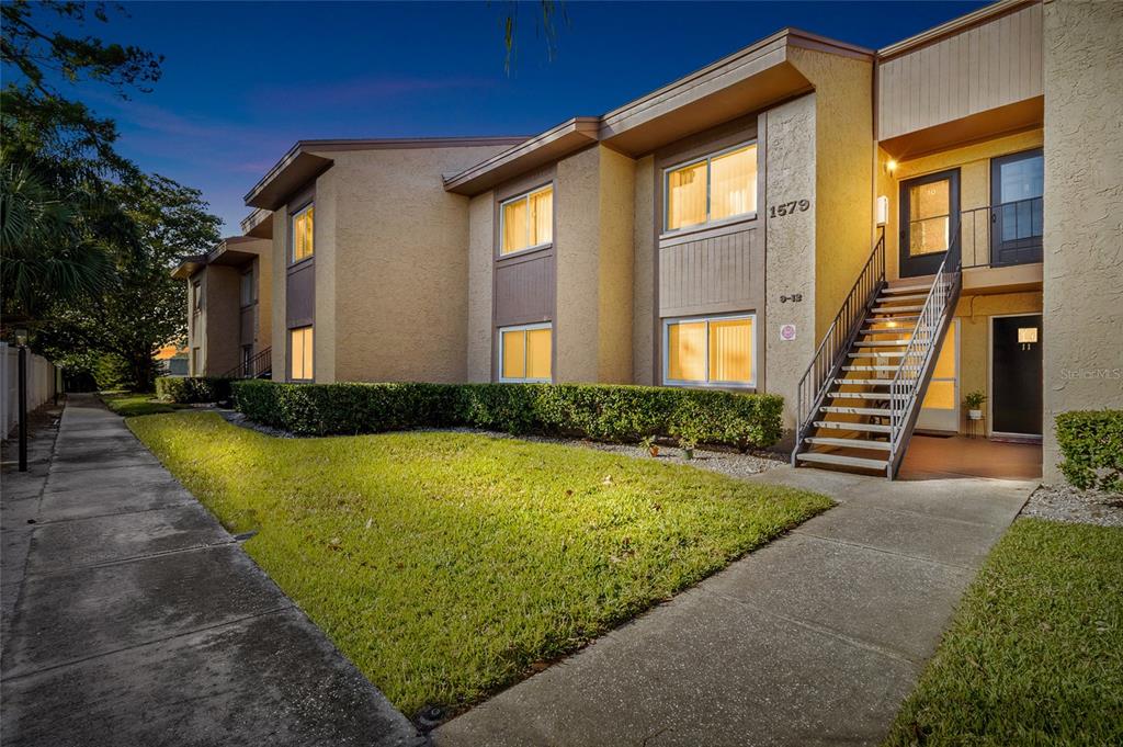 1579 Greenlea Drive, Unit 12 Clearwater, FL 33755 - Photo 2 of 42 a front view of a house with a yard
