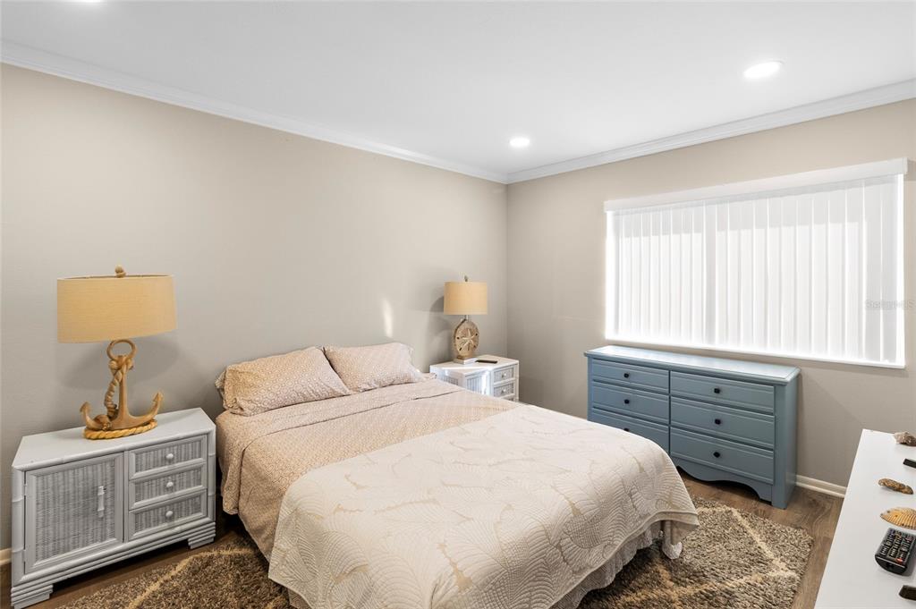 1579 Greenlea Drive, Unit 12 Clearwater, FL 33755 - Photo 21 of 42 a bedroom with a bed and a window