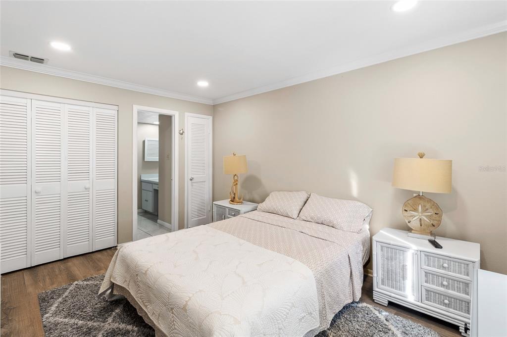 1579 Greenlea Drive, Unit 12 Clearwater, FL 33755 - Photo 23 of 42 a bedroom with a bed a dresser and a window