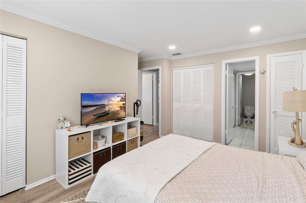 1579 Greenlea Drive, Unit 12 Clearwater, FL 33755 - Photo 24 of 42 a bedroom with a bed and a flat screen tv