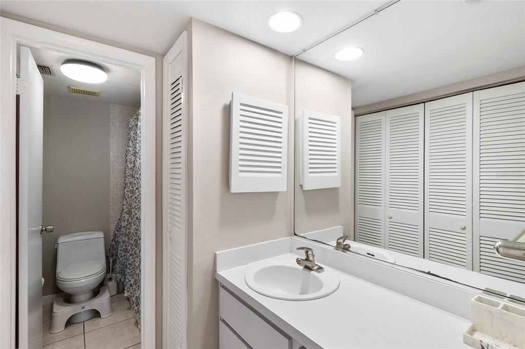 1579 Greenlea Drive, Unit 12 Clearwater, FL 33755 - Photo 25 of 42 a bathroom with a sink and a mirror
