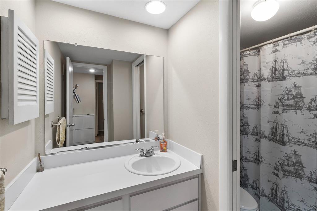 1579 Greenlea Drive, Unit 12 Clearwater, FL 33755 - Photo 27 of 42 a bathroom with a sink and a mirror